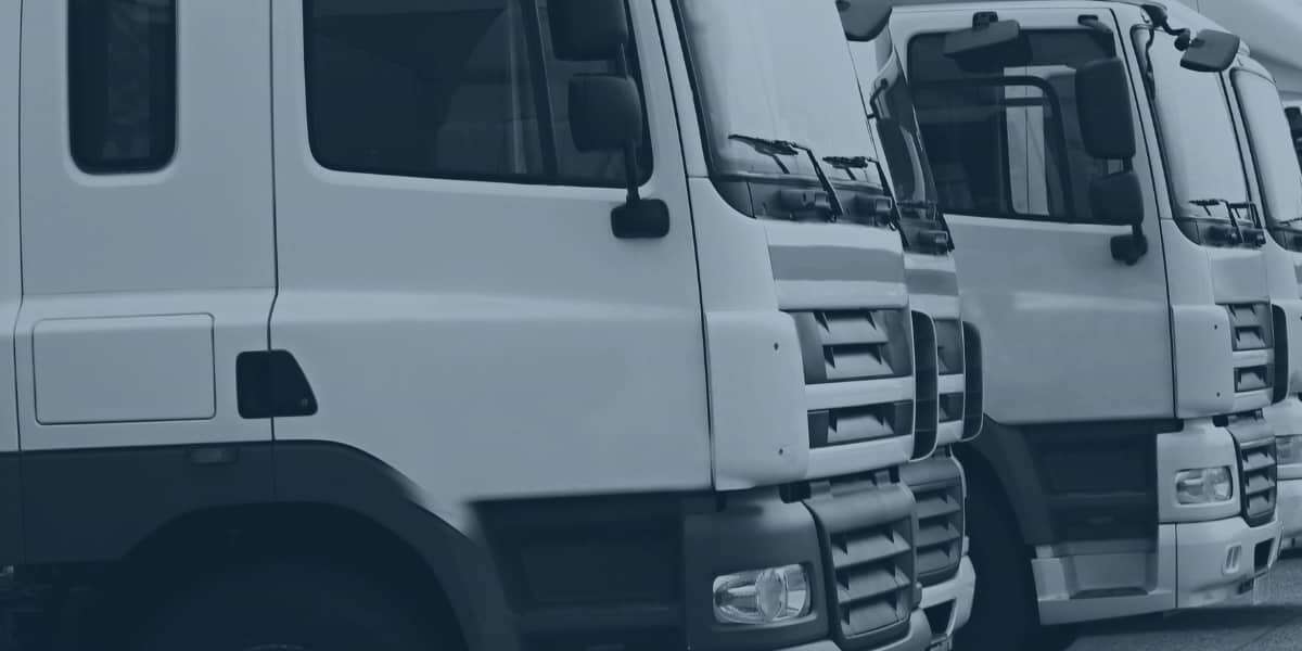 Stock photo of a distribution hub with a line up of lorries. Representing a blog post titled 