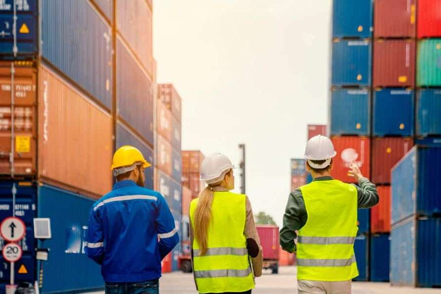 Stock image 3 people with shipping containers